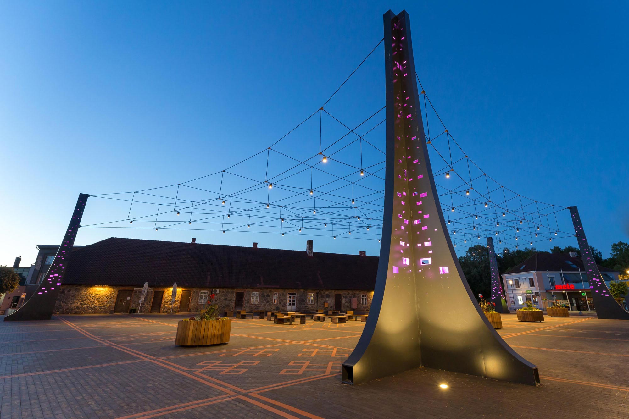 Tõrva Centre Square with LED illumination by Jakob Rope Systems at dusk