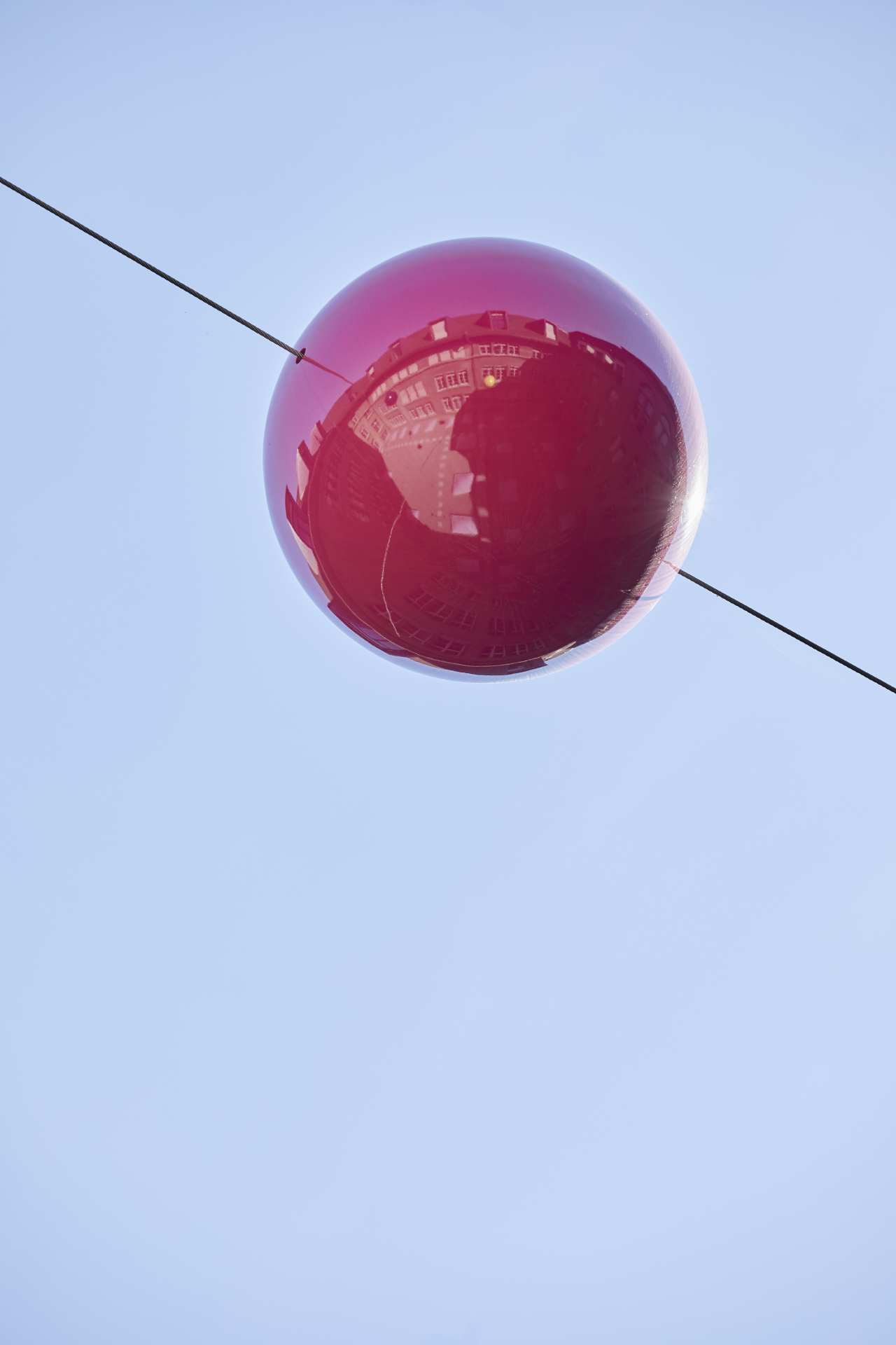 Red plastic ball on a cable as part of the installation