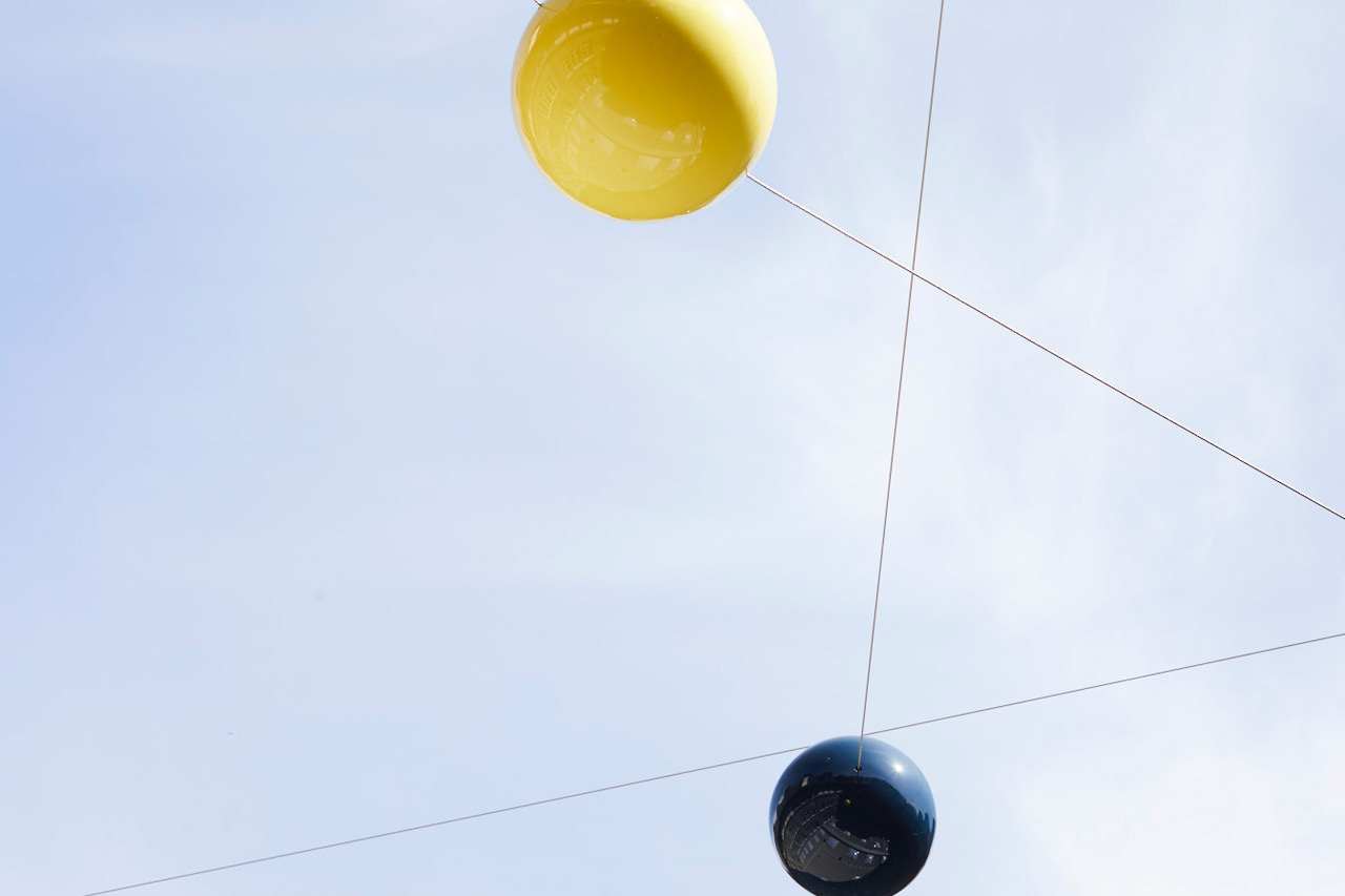 Yellow and blue plastics balls on intersecting cables