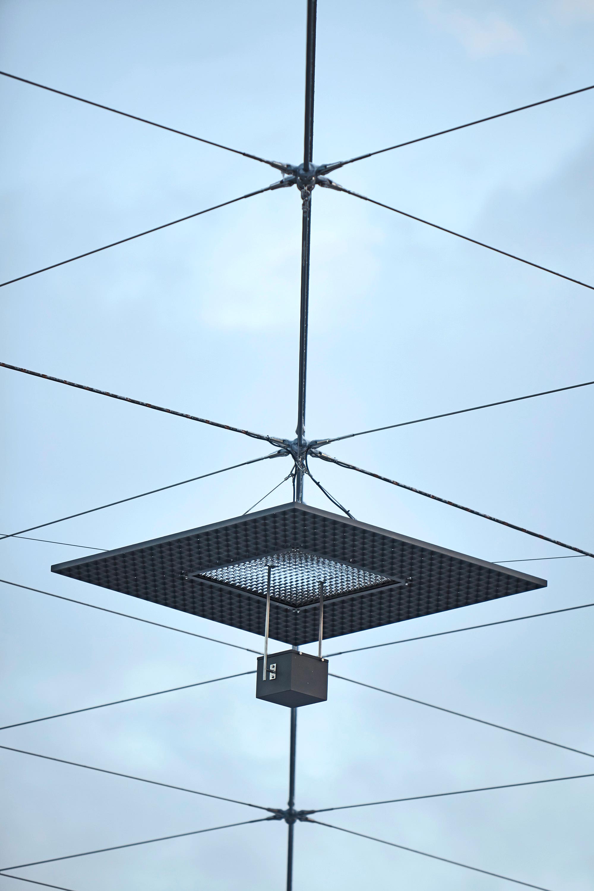 A street lantern hanging on a frame of Jakob steel cables