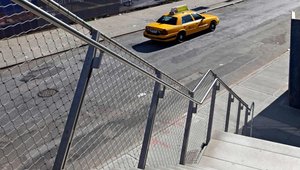 New York cab, stair with wire rope mesh railing in foreground