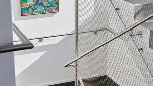 modern staircase secured with wire rope mesh